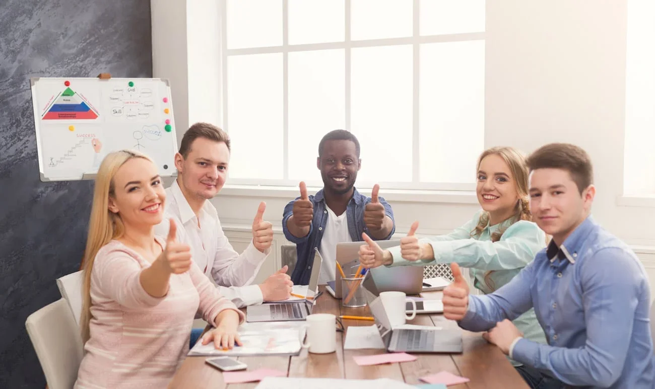 The Click Theory team giving thumbs up in a strategy meeting